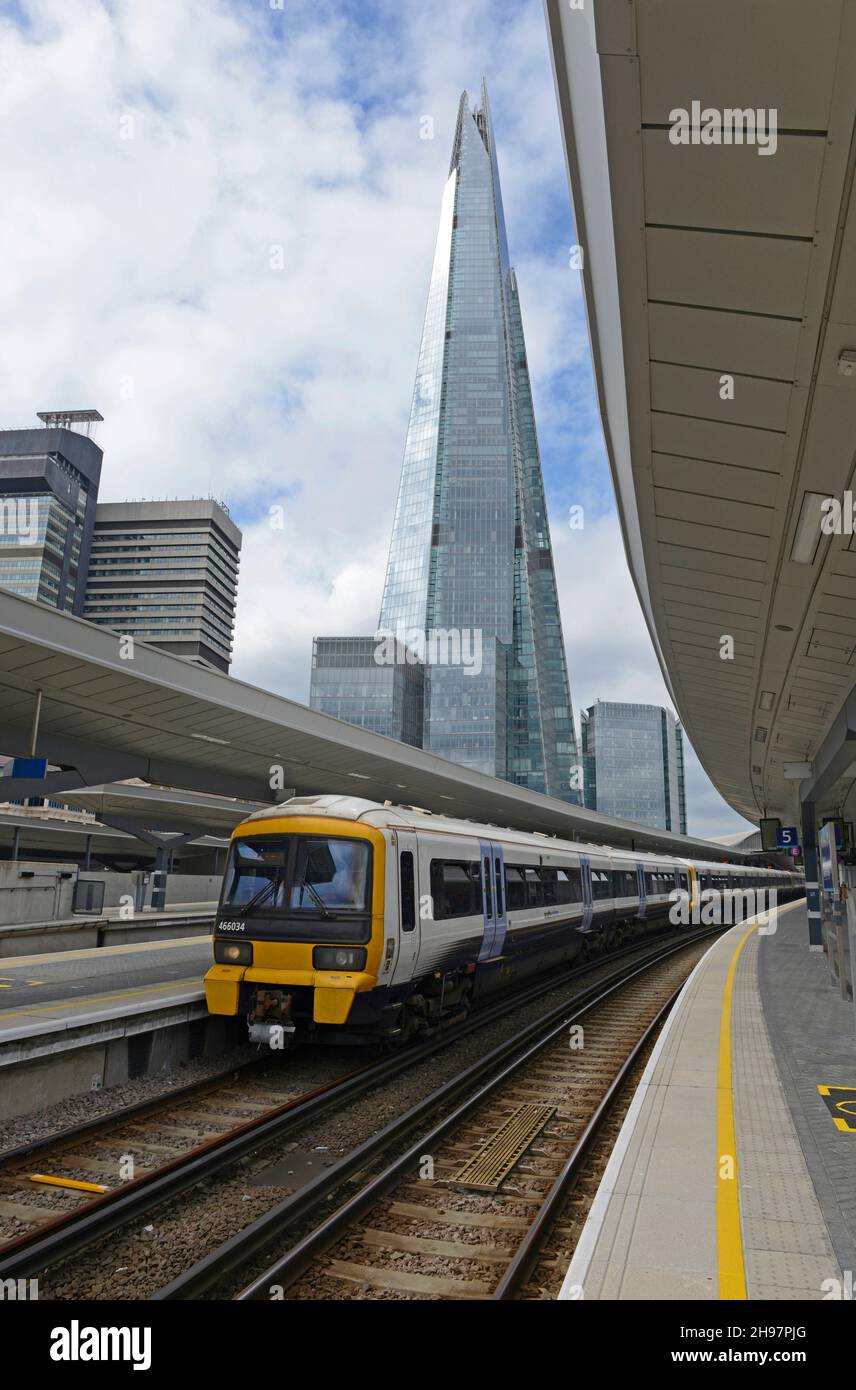 A Southeastern electric multiple unit train stands at a platform at London Bridge station with