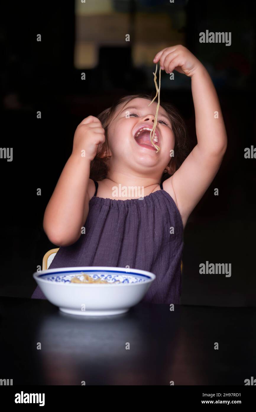 Child eating spagetti Stock Photo