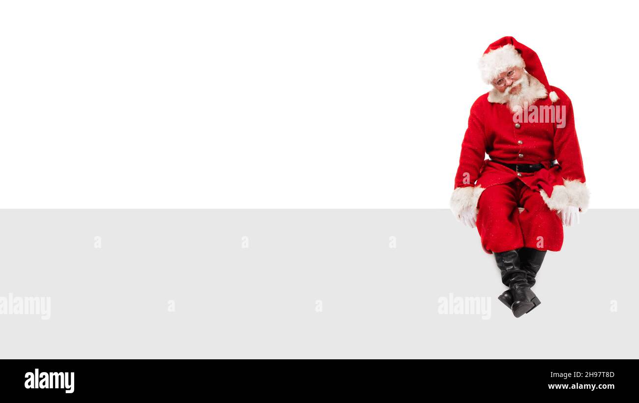 Santa Claus sitting on a blank panel isolated on white background Stock ...