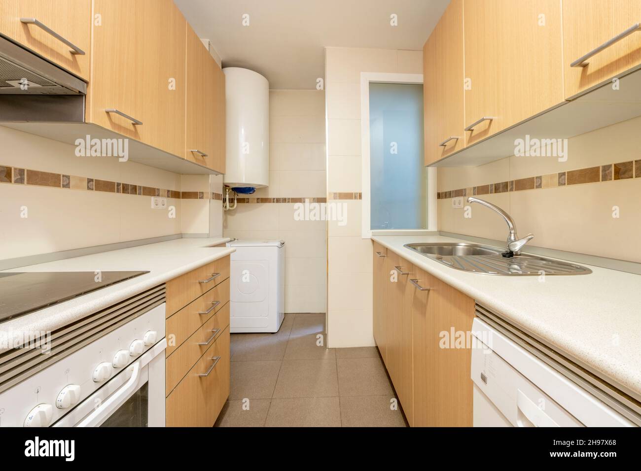 Closeup of classic cream-colored kitchen with appliances Stock Photo by  staRRush