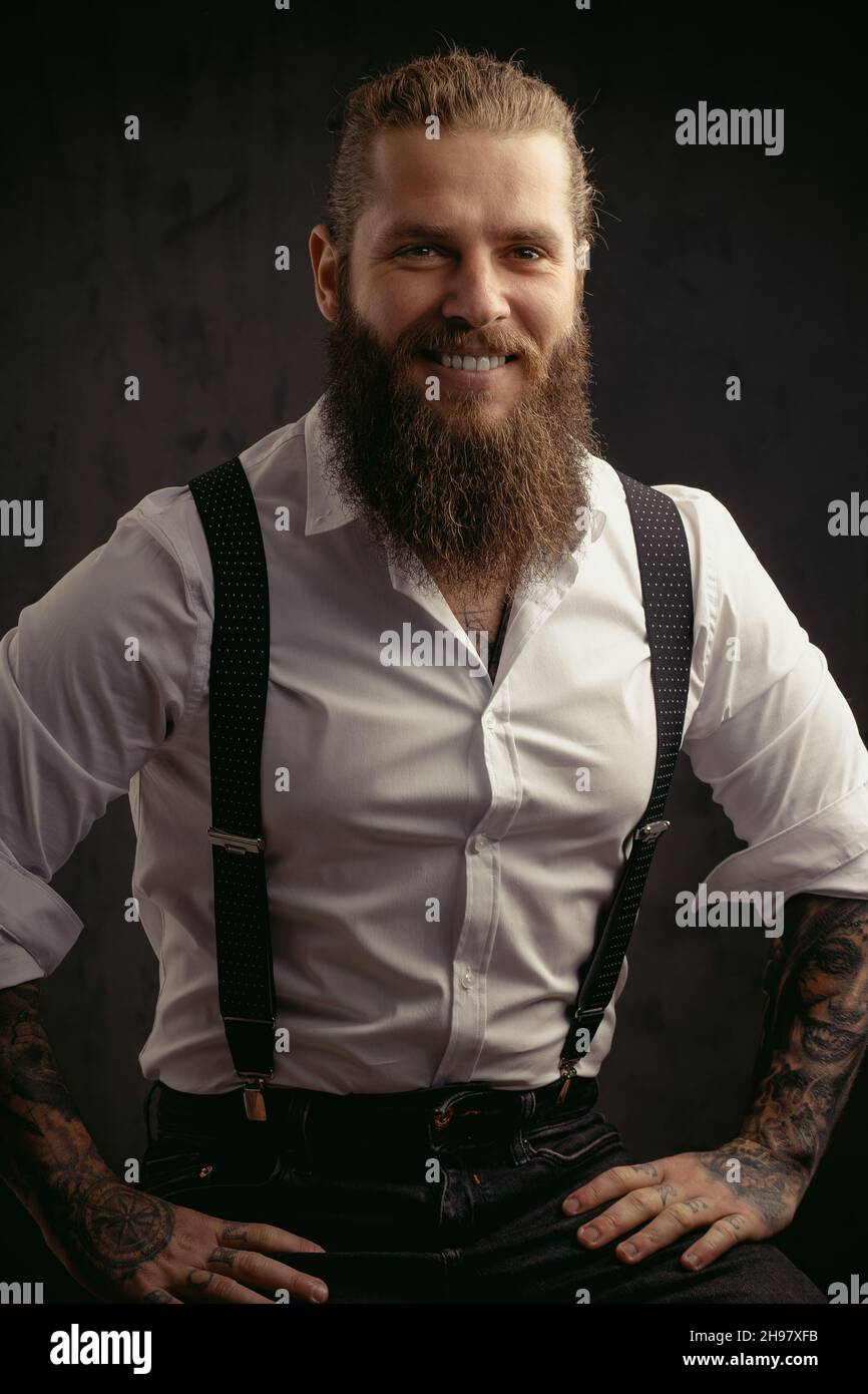 bearded man in suspenders. brutal guy wear bow tie. elegant male fashion  look. handsome hipster in formal wear. party goer. barbershop. mature  barber Stock Photo - Alamy