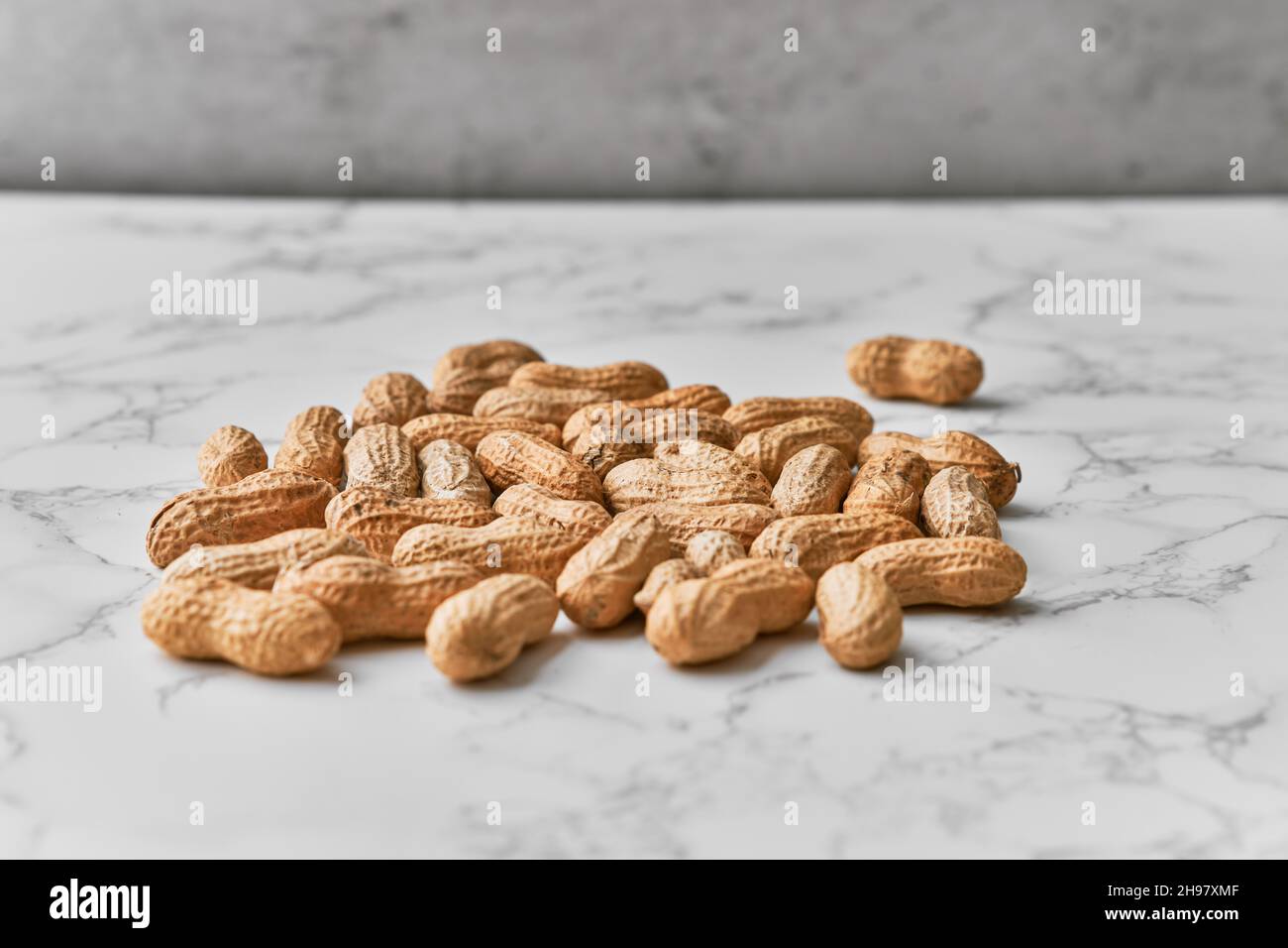 Image of bunch of peanuts on a marble table Stock Photo - Alamy