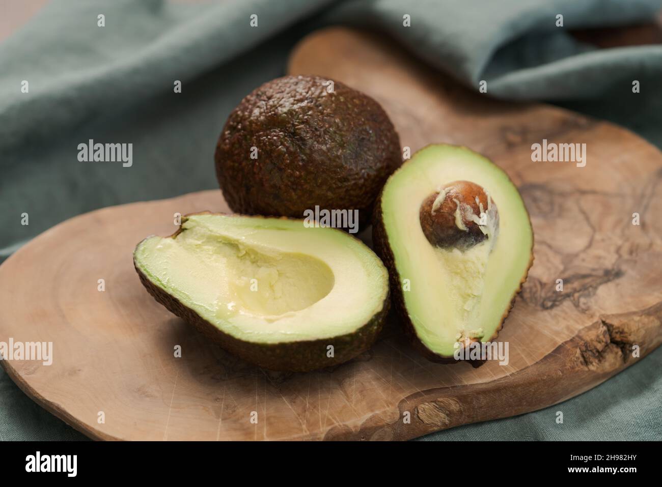 Avocado Stub Ripe Ripe avocados on olive wood board, shallow focus Stock Photo - Alamy