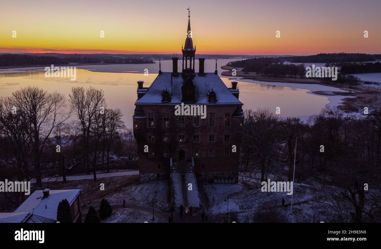 A drone shot of the Wiks (Viks) Castle after the first snow during a Christmas market at sunset, December 2021, Sweden Stock Photo