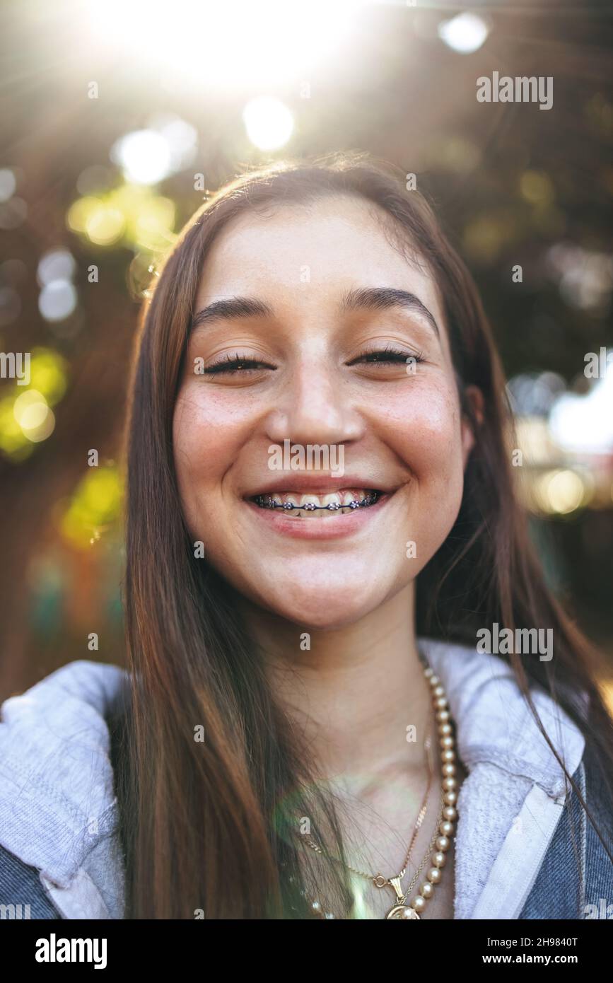 Adorable teenage girl with braces smiling cheerfully. Closeup of a