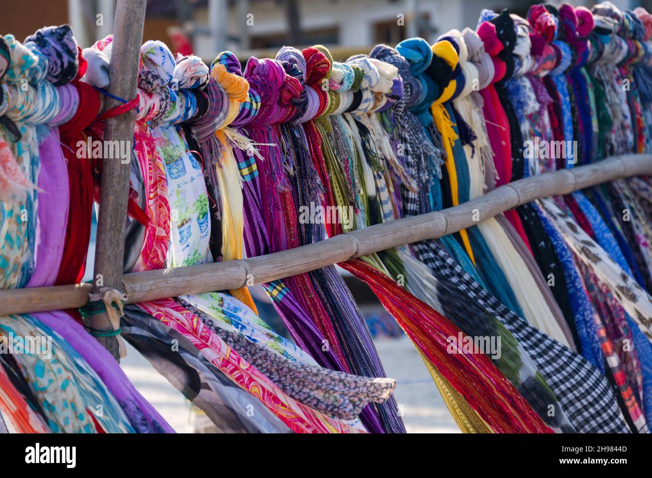Colourful traditional fabric garments on display for sale on beach, Diani, Kenya Stock Photo