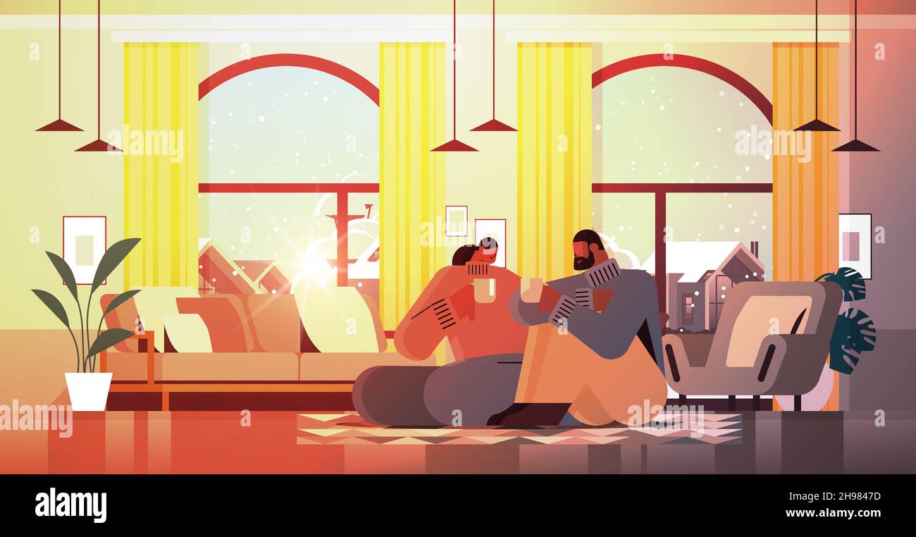 african american couple drinking coffee and talking together at home ...