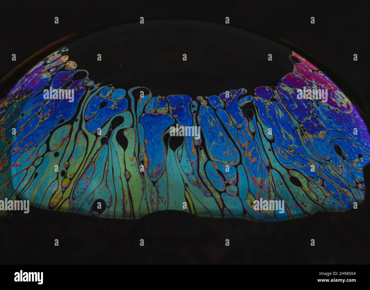 Beautiful psychedelic abstractions on the surface soap bubbles. Stock Photo