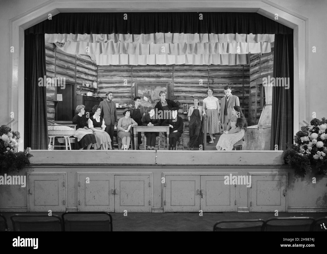 Goodwyn Hall, Mill Hill, Barnet, London, 21/10/1961. Members of the Dramatic Section of the Laing Sports Club on stage at Goodwyn Hall, performing their take on the play 'Johnny Belinda' by Elmer Harris. The Sports Club Dramatic Section performed the play 'Johnny Belinda' on the 19th, 20th and 21st October 1961 at Goodwyn Hall, Mill Hill. The play is set in the extreme north of Canada and tells the story of a young girl who is deaf. At the door donations raised a total of &#xa3;8 and 10s for the Royal Association in Aid of the Deaf and Dumb. This image was published in December 1961 in Laing's Stock Photo