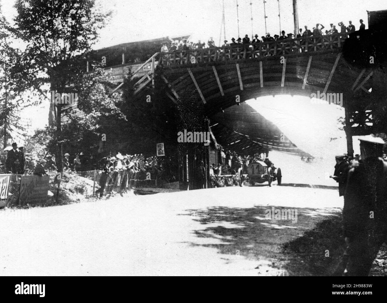 FIAT of Italian racing driver Luigi Storero going under a bridge during the 1904 Gordon Bennett Cup, Homburg, Germany. Storero failed to finish the race. Stock Photo