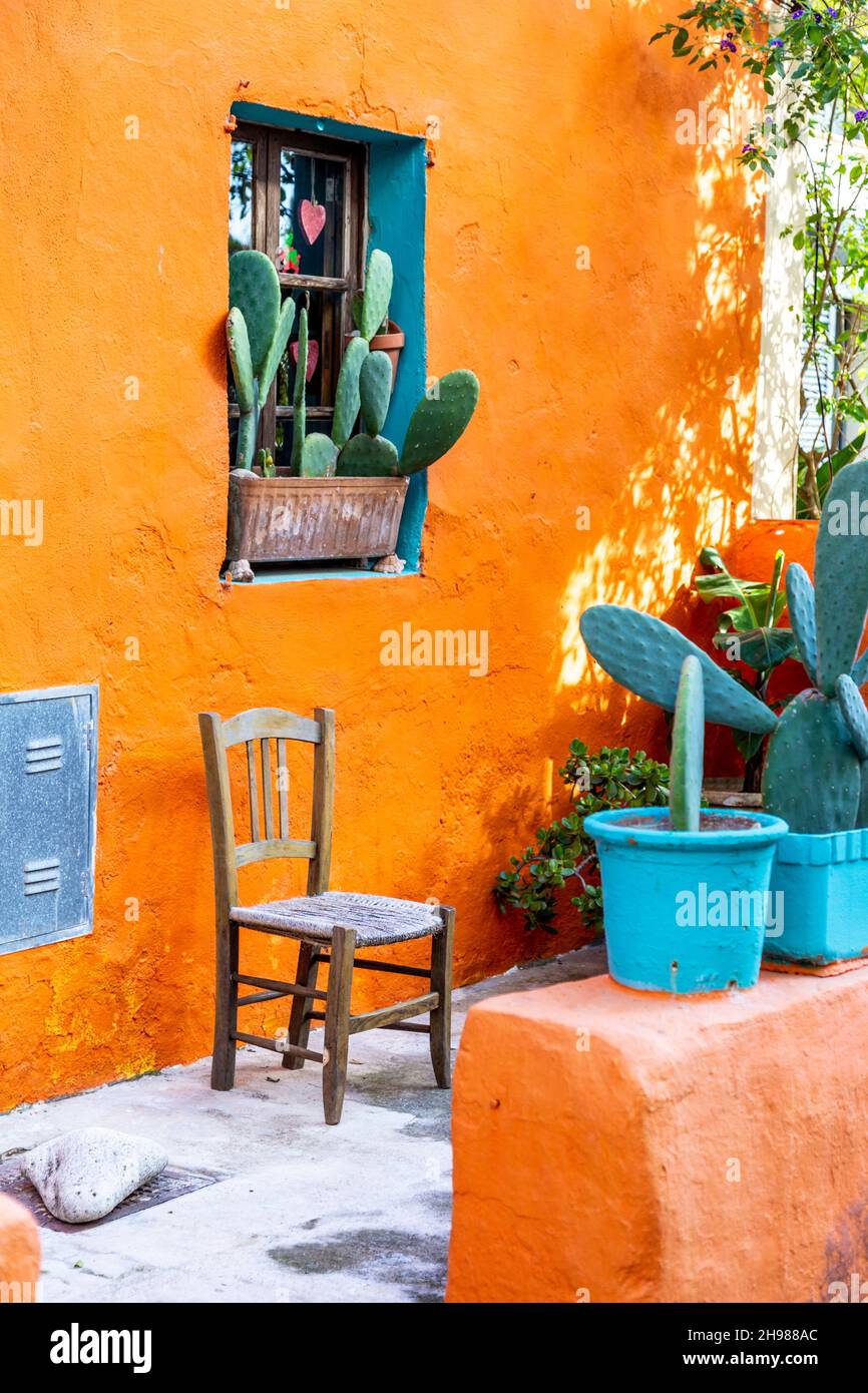 Vibrant orange house with potted cactus plants in on Carrer del Polvorí, El Terreno, Palma, Mallorca, Spain Stock Photo