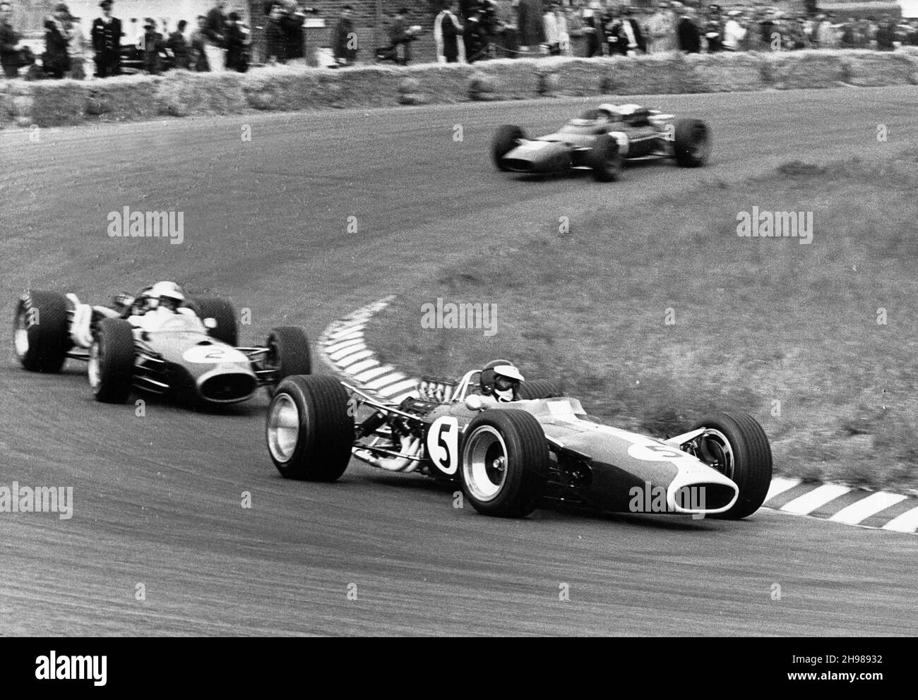 Jim Clark driving his Lotus 49 R3 DFV to victory at the Dutch Grand Prix, Zandvoort, Netherlands, 1967. Immediately behind Clark is Denny Hulme's Brabham-Repco which finished third. Stock Photo