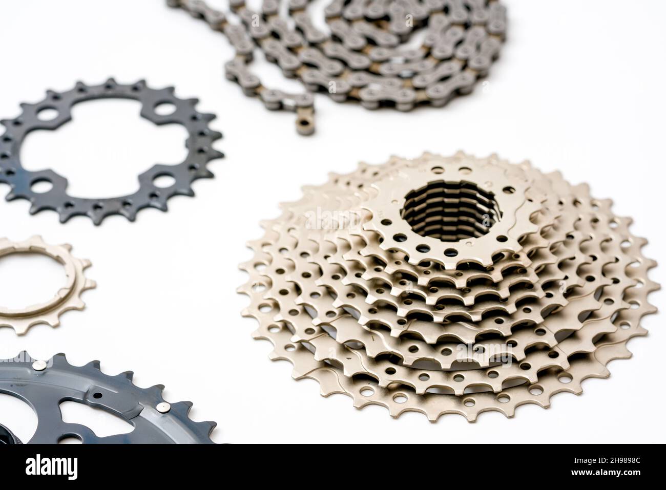 Gears, sprockets and chain of a mountain sports bike on a white