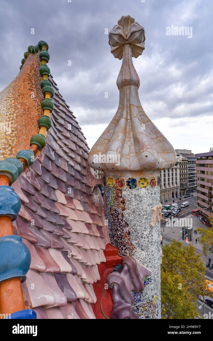 Barcelona, Spain - 22 Nov, 2021: View of famous rooftop of Casa Batllo designed by Antoni Gaudi, Barcelona, Spain showing scales of dragon and chimney Stock Photo