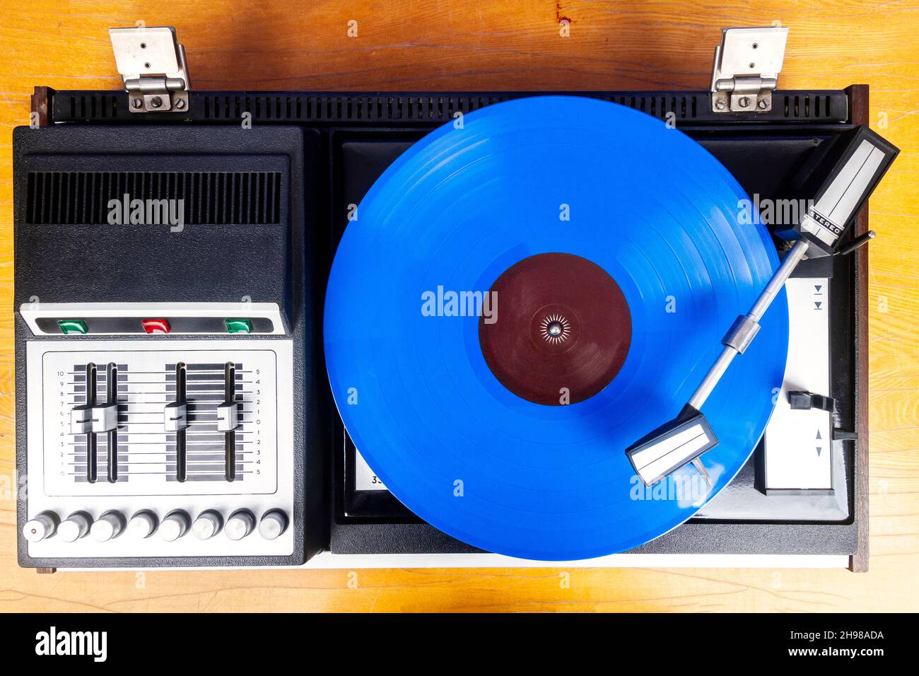 Vintage turntable vinyl record player with blue vinyl on a table Stock ...