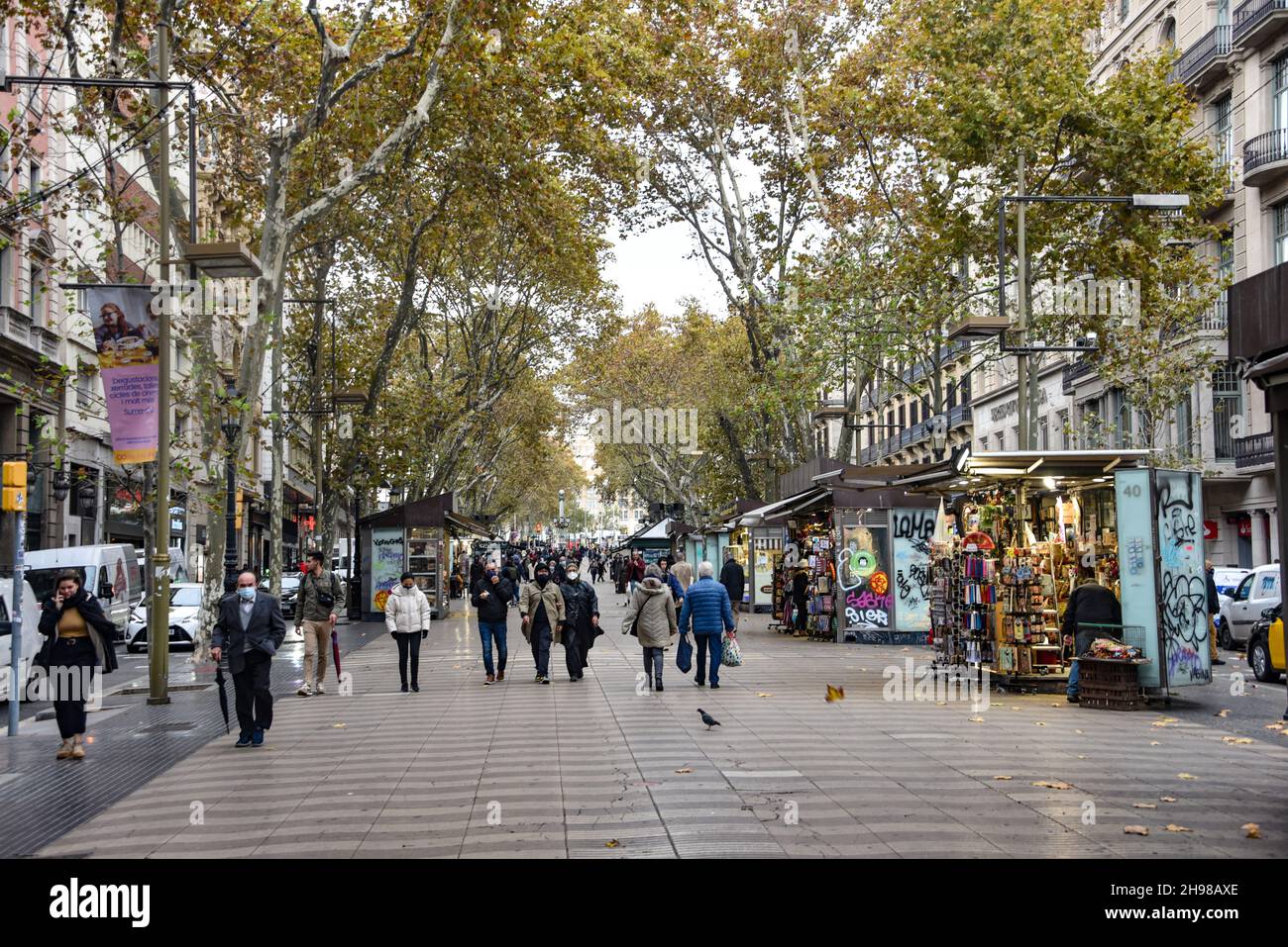 Barcelona, Spain - 23 Nov, 2021: Crowds strolling along the famous La Rambla avenue on an Autumn day, Barcelona, Spain Stock Photo