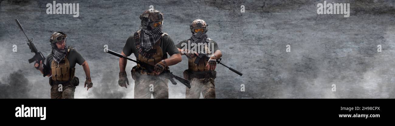 Photo format 4x1 - three military mercenaries walk against the background of a concrete wall and smoke. Photo with copy space. Collage - one model in Stock Photo