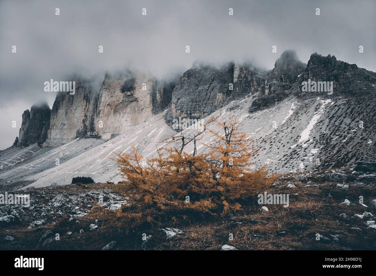 Incredible view of the Three Peaks of Lavaredo in morning fog. National Park Tre Cime di Lavaredo, Dolomite Alps mountains, Trentino Alto Adige region, Sudtirol, Dolomites, Italy Stock Photo