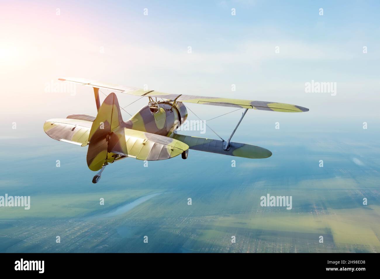 Vintage turboprop plane flying in the sky speed effect, back view Stock