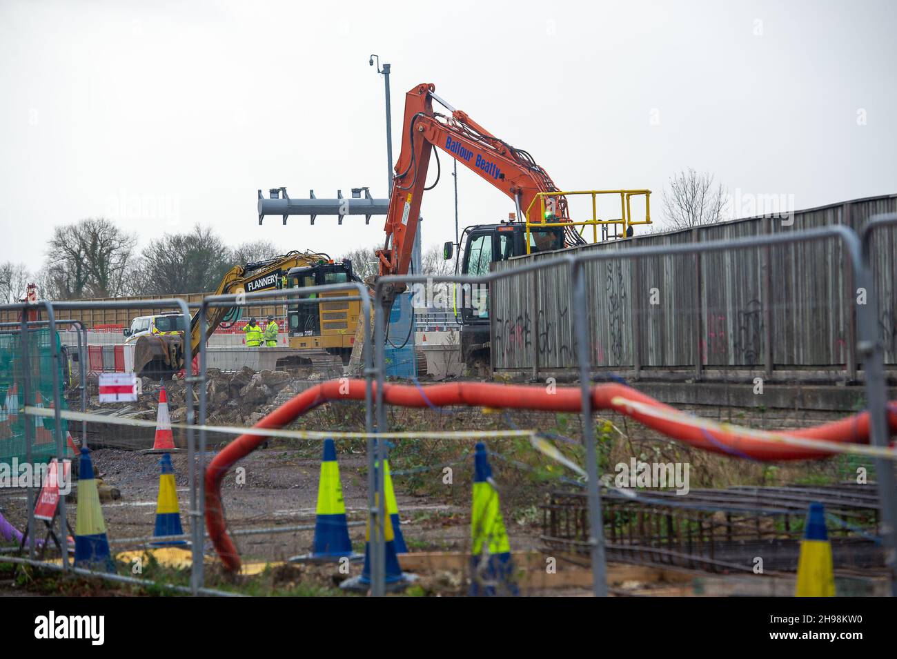 Dorney Reach, Buckinghamshire, UK. 5th December, 2021. Construction workers were demolishing a wall next the pedestrian footpath adjacent to the M4 today causing noise and dust for villagers in Dorney Reach. The M4 is closed again this weekend in both directions between Junction 6 for Slough and Junction 8/9 at Maidenhead. The M4 is being upgraded to an All Lanes Running Digital Smart Motorway which will no longer have a hard shoulder but intermittent refuge areas for break downs. 38 people have died on Smart Motorways in the past five years in the UK. A Smart Motorway upgrade on the M3 has be Stock Photo