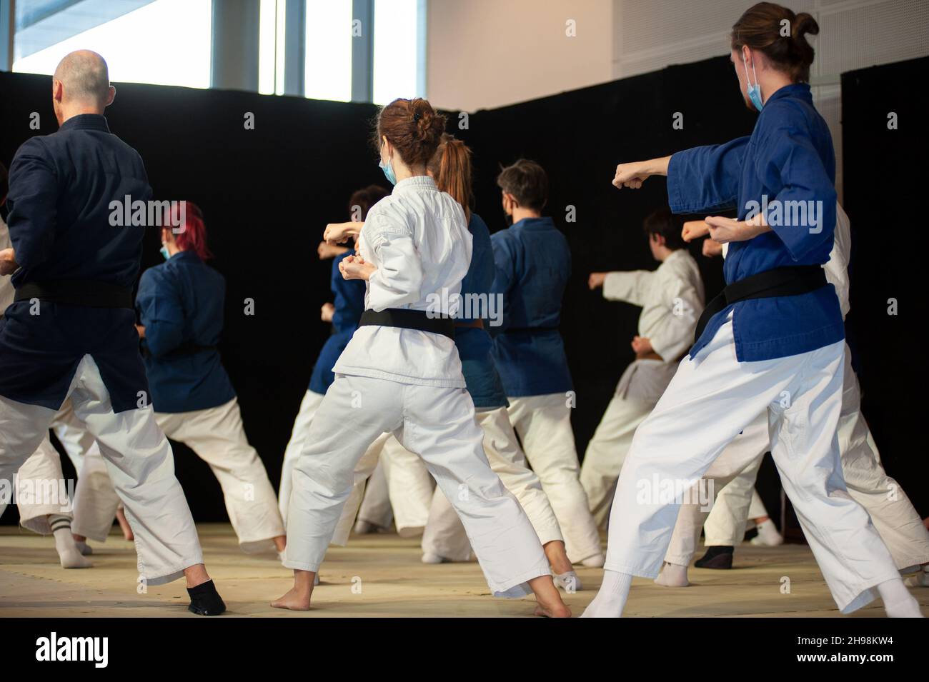 Athletes of Karate during a training session. Mawashi Zuki position. Stock Photo