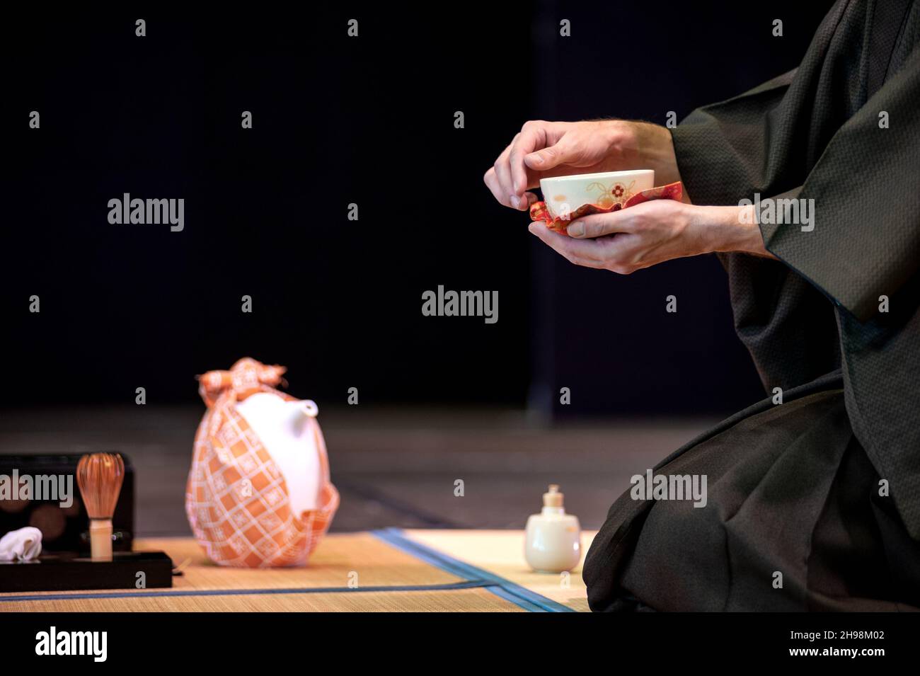 Japanese master in traditional kimono, during the tea ceremony. Copy space. Stock Photo
