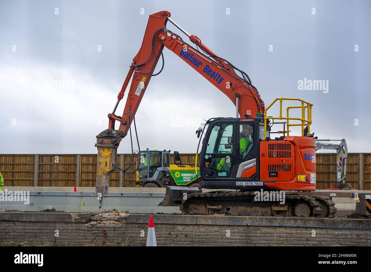 Dorney Reach, Buckinghamshire, UK. 5th December, 2021. Construction workers were demolishing a wall next the pedestrian footpath adjacent to the M4 today causing noise and dust for villagers in Dorney Reach. The M4 is closed again this weekend in both directions between Junction 6 for Slough and Junction 8/9 at Maidenhead. The M4 is being upgraded to an All Lanes Running Digital Smart Motorway which will no longer have a hard shoulder but intermittent refuge areas for break downs. 38 people have died on Smart Motorways in the past five years in the UK. A Smart Motorway upgrade on the M3 has be Stock Photo