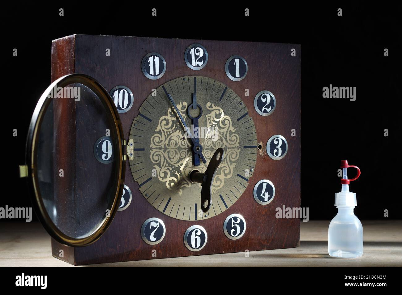 Old mechanical clock in a wooden case. Mechanical watch and oil