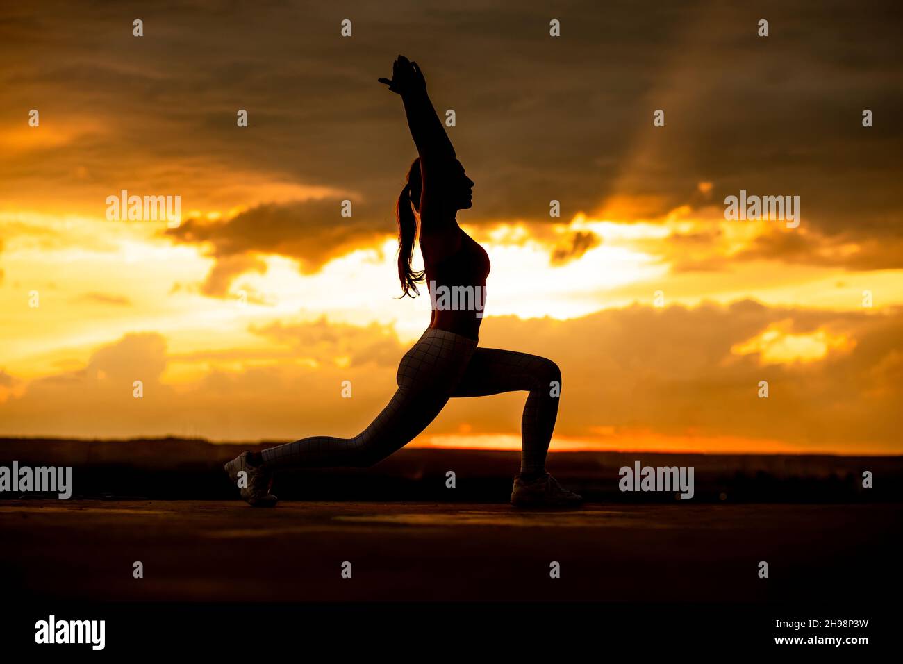 Sunset yoga. Beautiful yoga girl silhouette at the sunset Stock Photo ...