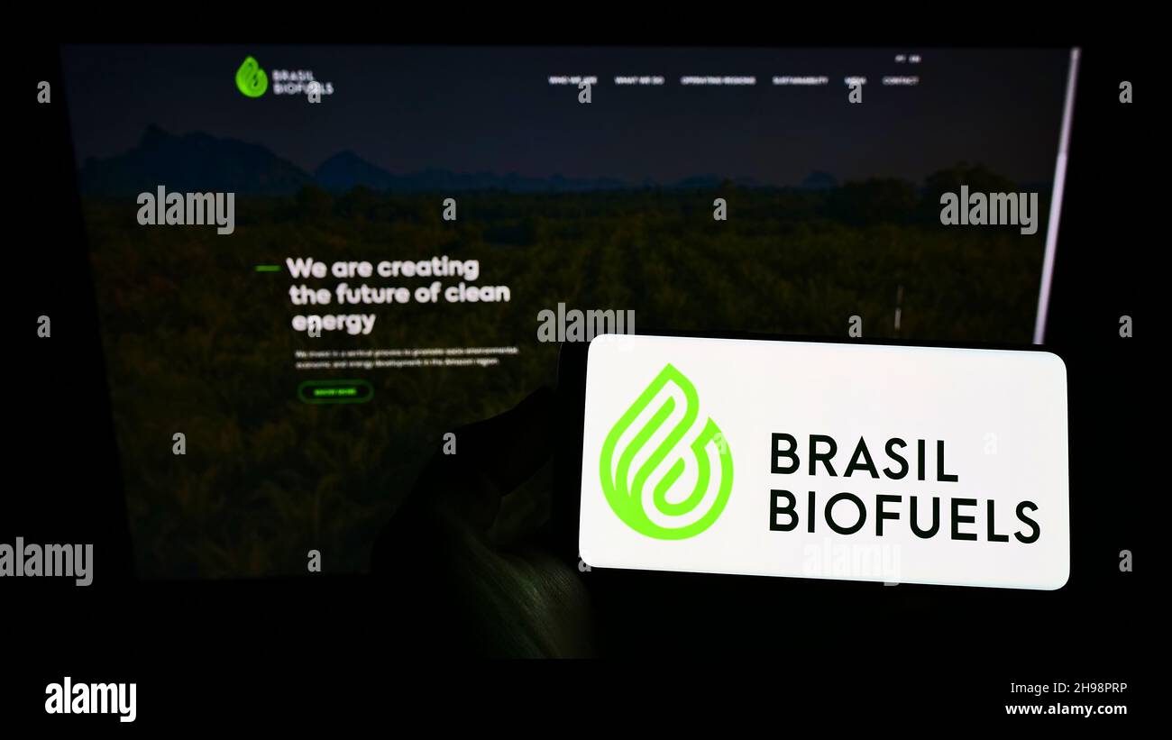 Person holding smartphone with logo of company BBF Brasil Bio Fuels S.A. (BioFuels) on screen in front of website. Focus on phone display. Stock Photo