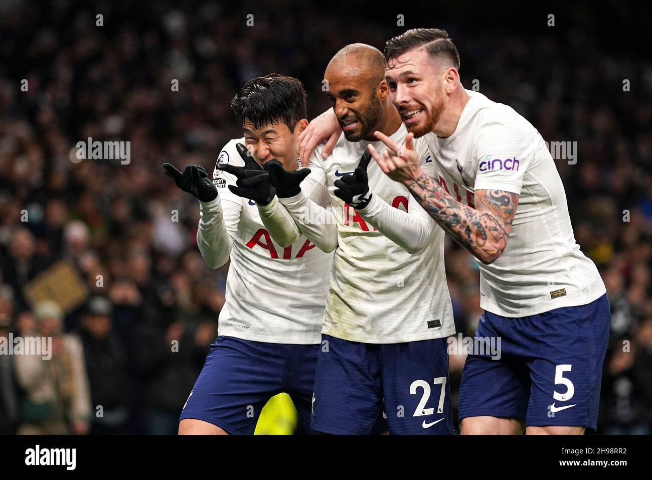 Tottenham Hotspur's Son Heung-min (left) celebrates scoring their side's third goal of the game with Tottenham Hotspur's Lucas Moura (centre) and Tottenham Hotspur's Pierre-Emile Hojbjerg (right) during the Premier League match at Tottenham Hotspur Stadium, London. Picture date: Sunday December 5, 2021. Stock Photo