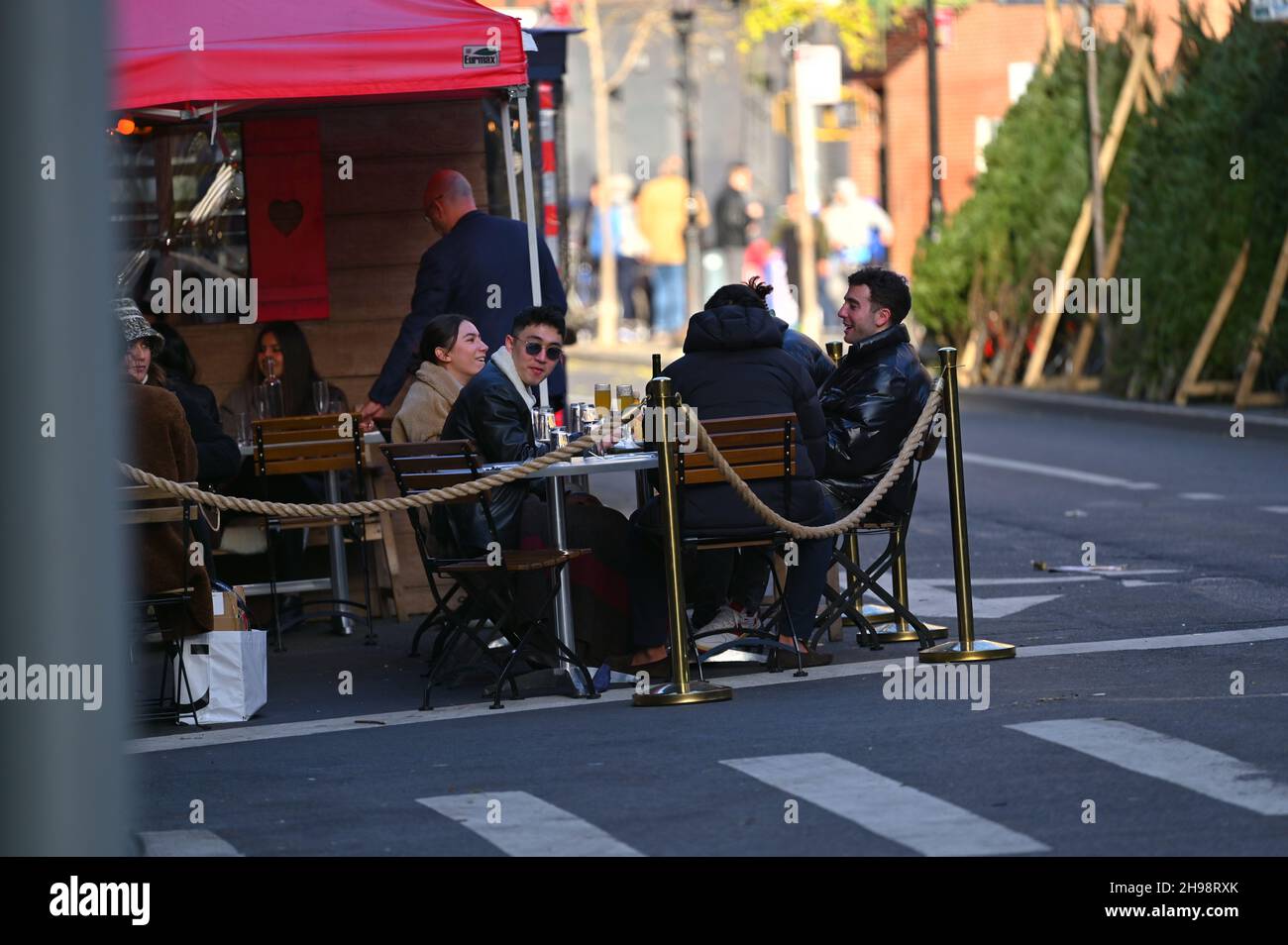People are having a lunch in the outdoor area of a restaurant in