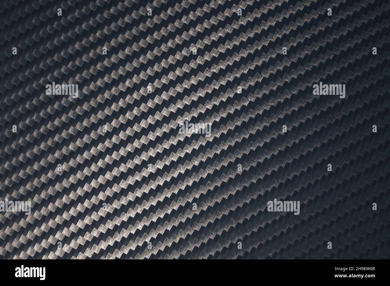Macro of woven carbon fibre sheet surface. Diagonal orientation of