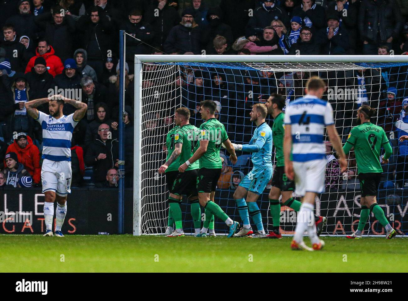 Queens Park Rangers' Charlie Austin (left) shows his disappointment after Stoke City goalkeeper Adam Davies saves his penalty during the Sky Bet Championship match at the Kiyan Prince Foundation Stadium, London. Picture date: Sunday December 5, 2021. Stock Photo