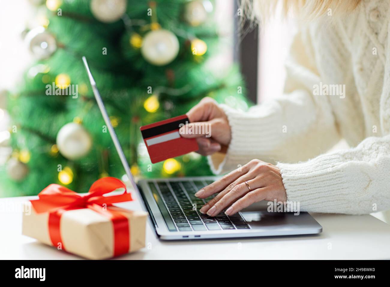 Young woman Paying online with credit card, holiday shopping. Person using technology Stock Photo