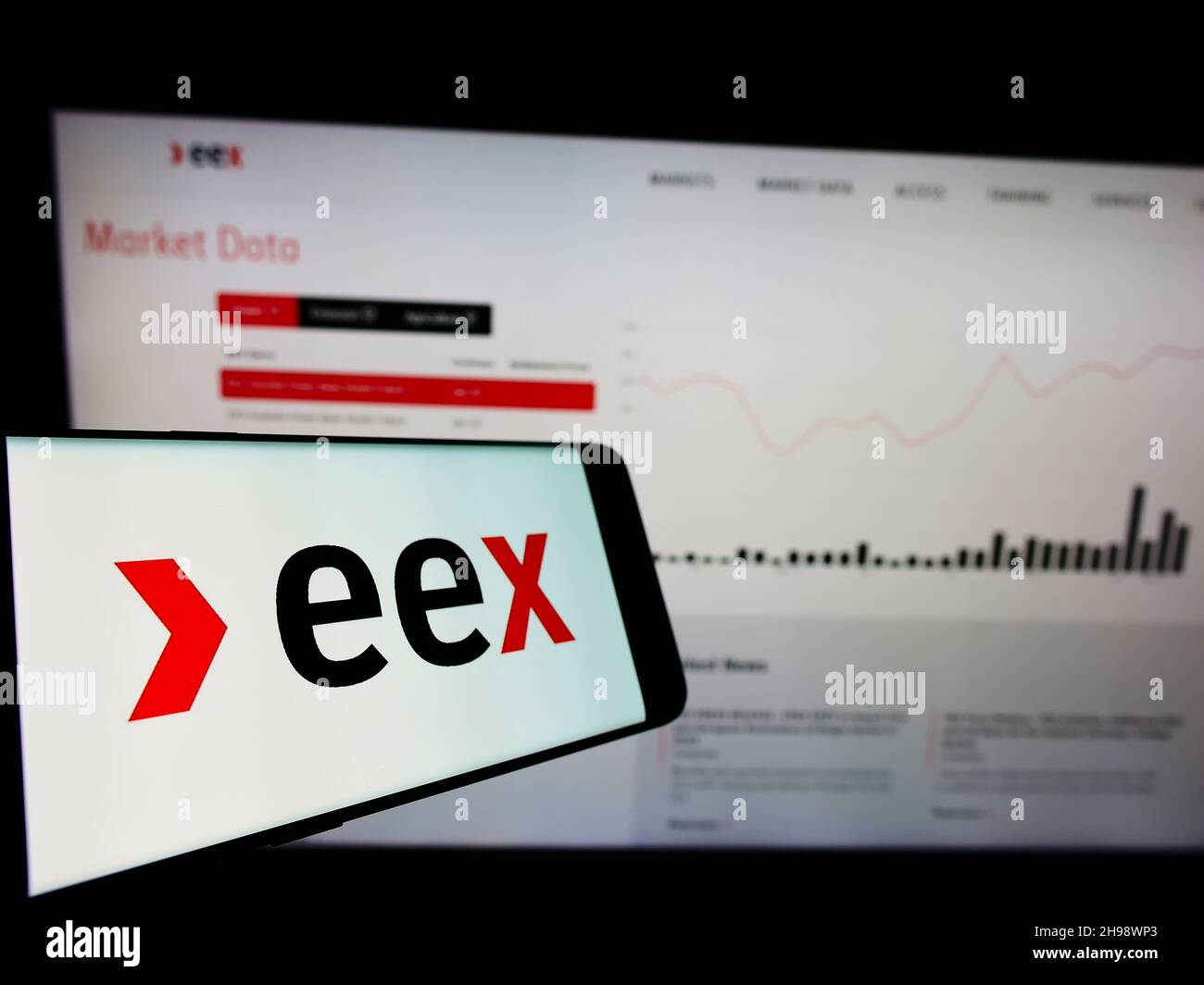 Mobile phone with logo of German company European Energy Exchange AG (EEX) on screen in front of business website. Focus on center of phone display. Stock Photo