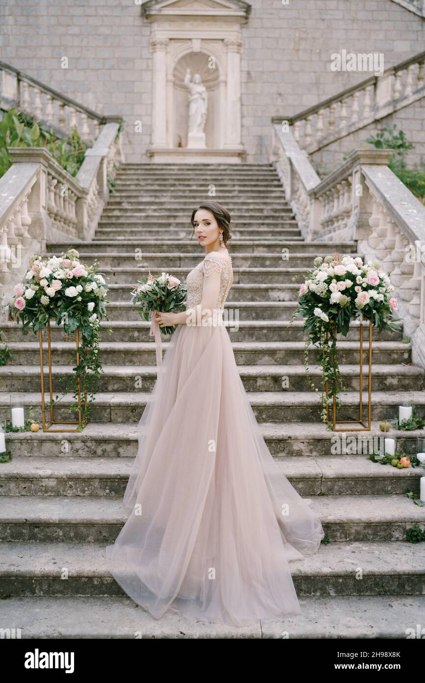 Bride with a bouquet on the stone steps of an ancient villa Stock Photo ...