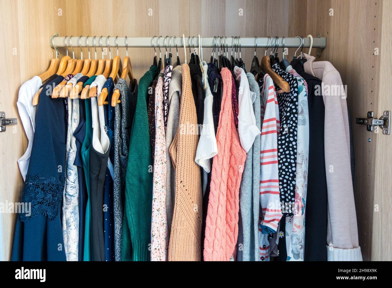 Wardrobe with Women clothes on hanger Stock Photo