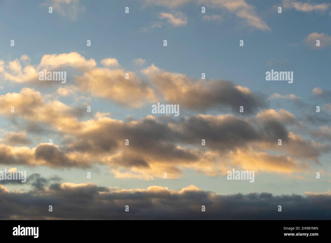 Cloudscape at dusk with gathering cumulus clouds. Stock Photo