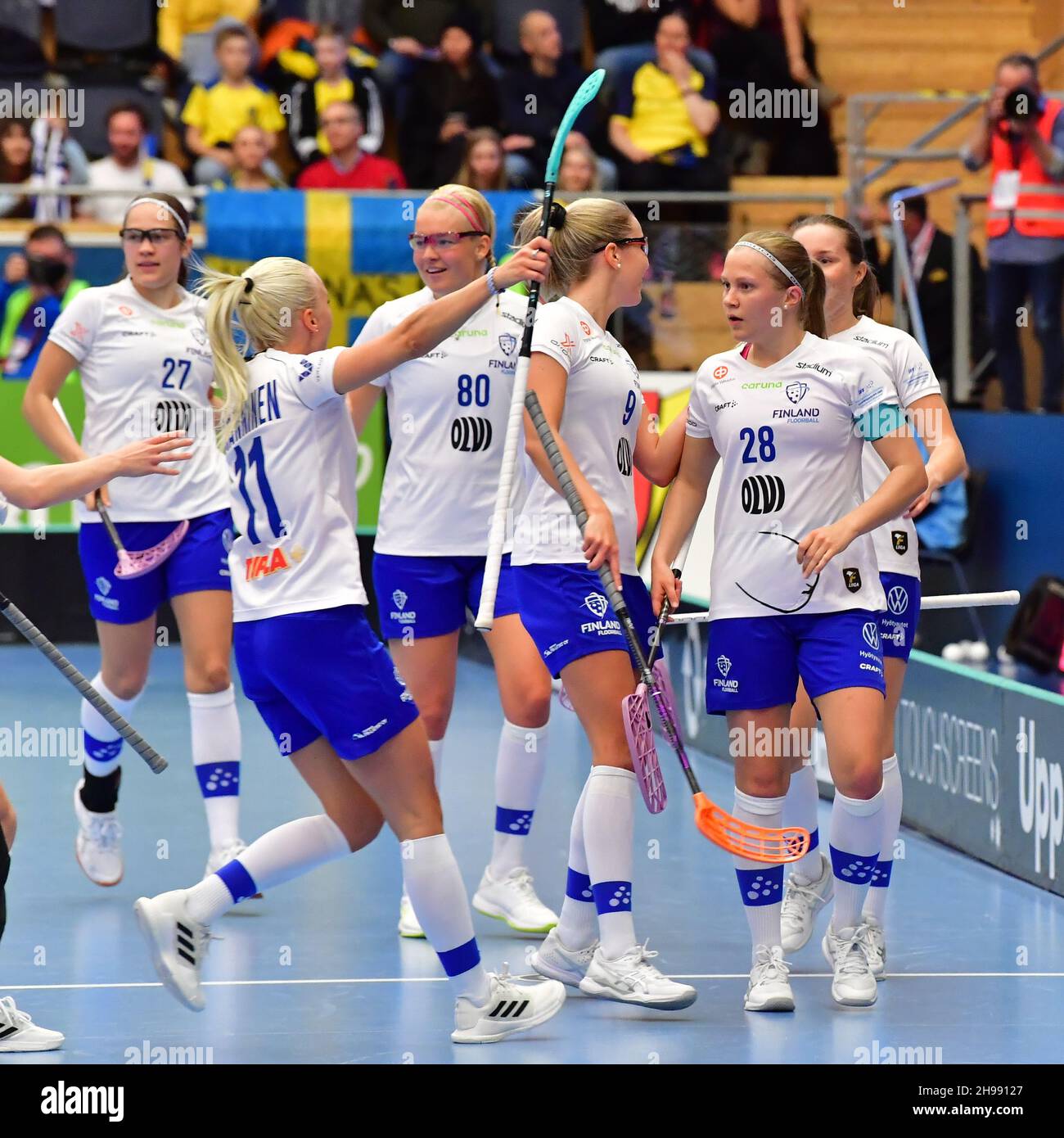 Finland's Veera Kauppi (#28, R) celebrates a goal with her team mates during the final between Finland and Sweden at the Women's World floorball Champ Stock Photo