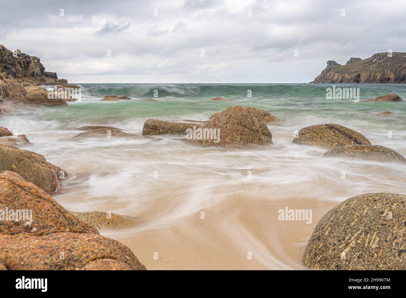 The beautiful sandy beach of Nanjizal (Mill Bay) with it's amazing boulders in Cornwall Stock Photo