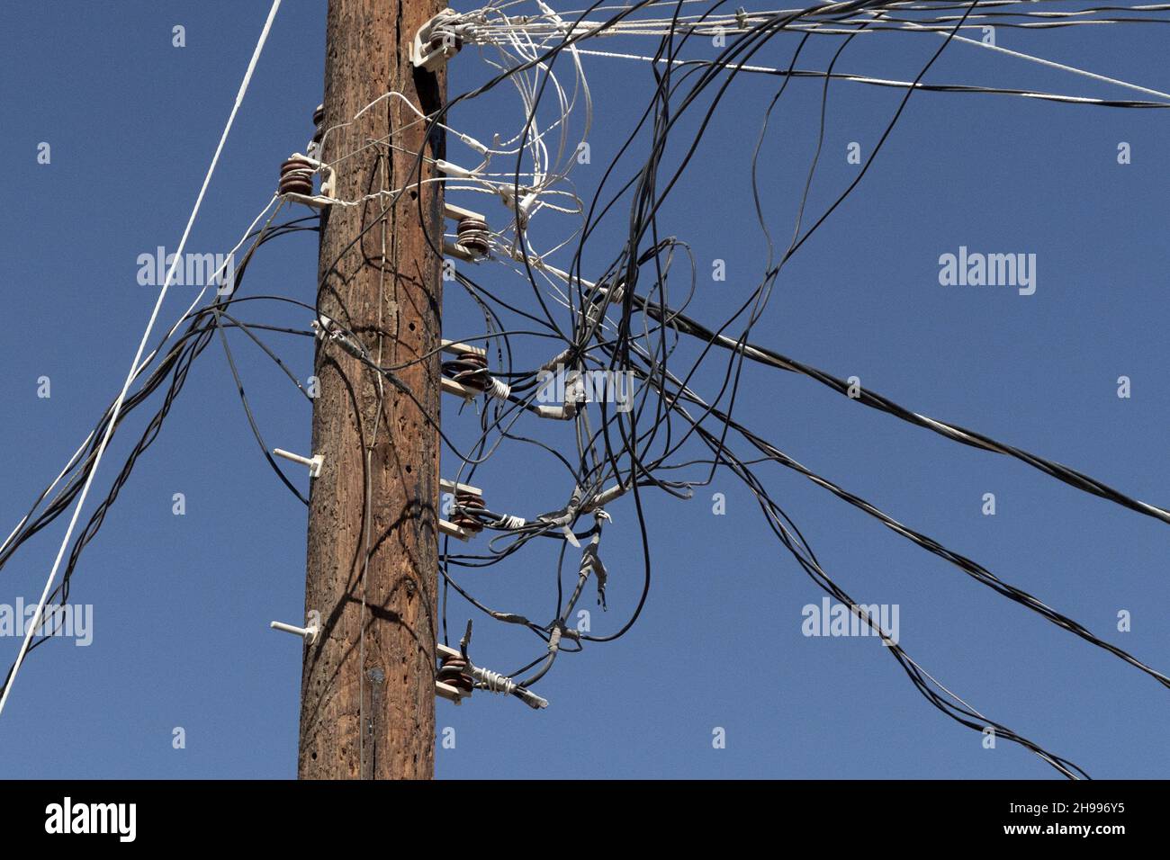 Many cables telephone electricity wires together on a pole Stock Photo ...