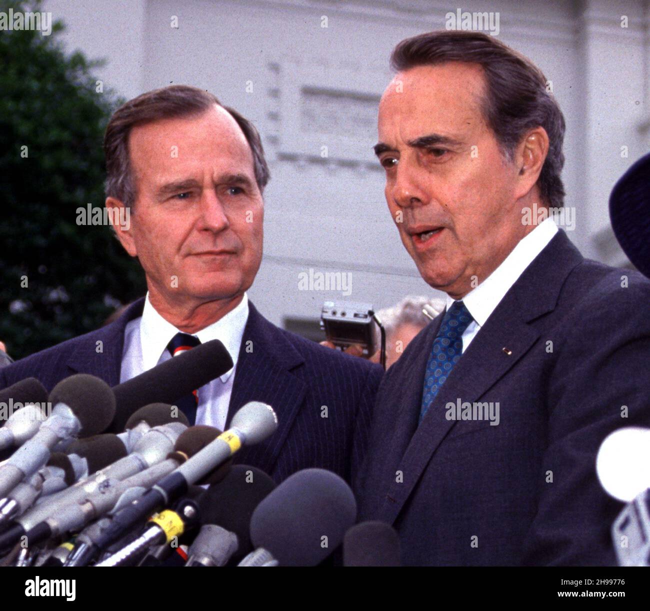 **FILE PHOTO** Bob Dole Has Passed Away at 98. United States President-elect George H.W. Bush and U.S. Senate Minority Leader Bob Dole (Republican of Kansas) meet reporters after their luncheon meeting in the Old Executive Office Building in Washington, DC on November 28, 1988.Credit: Ron Sachs /MediaPunch Stock Photo