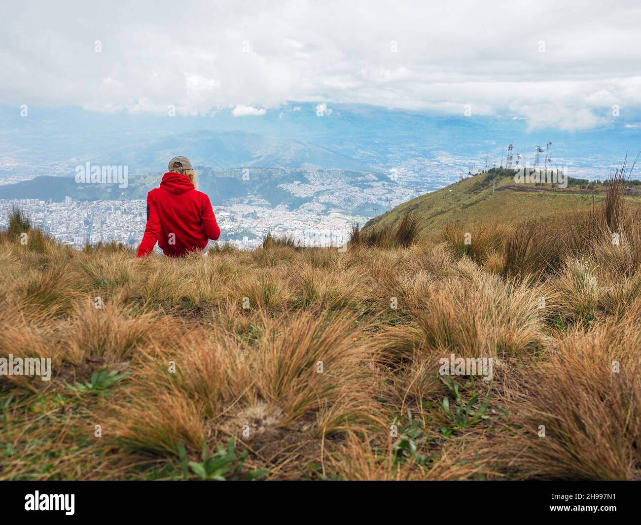 Woman in the mountain top enjoying view over the Quito city. Andes