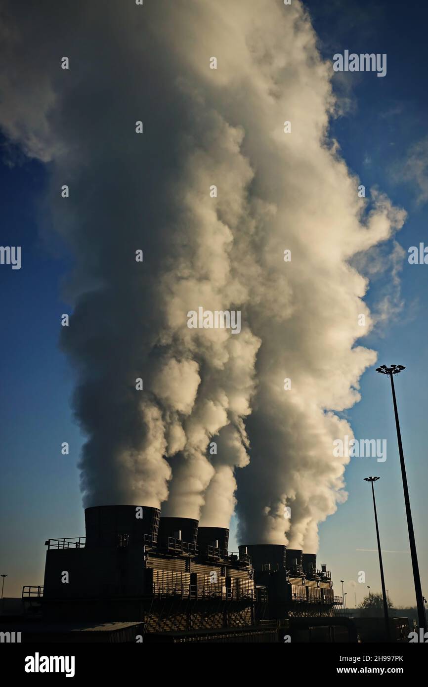 Factory chimneys with smoke emission. Industrial factory pollution, smokestack exhaust gases. factory chimney Stock Photo