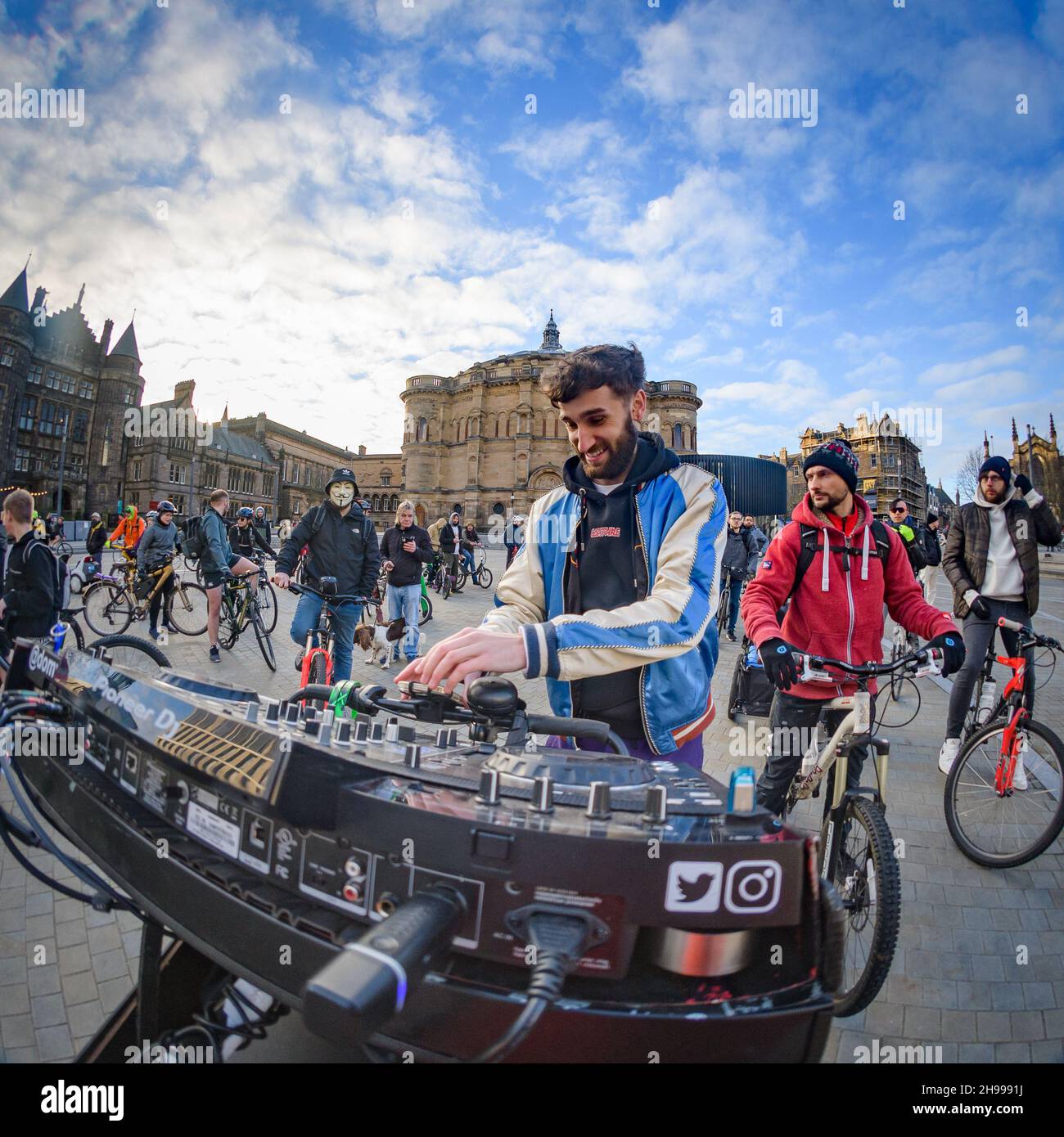 Edinburgh, Scotland. Sunday 5 December 2021. DJ Dom Whiting leads a mass bike ride through the streets of Edinburgh. Better known as the 'DJ on a Bike', he had been frustrated at not being able to help stage parties during lockdown with the events company Audio Venom so bought a three-wheeled bike and mounted his turntables on the handlebars to provide outdoor music. Stock Photo