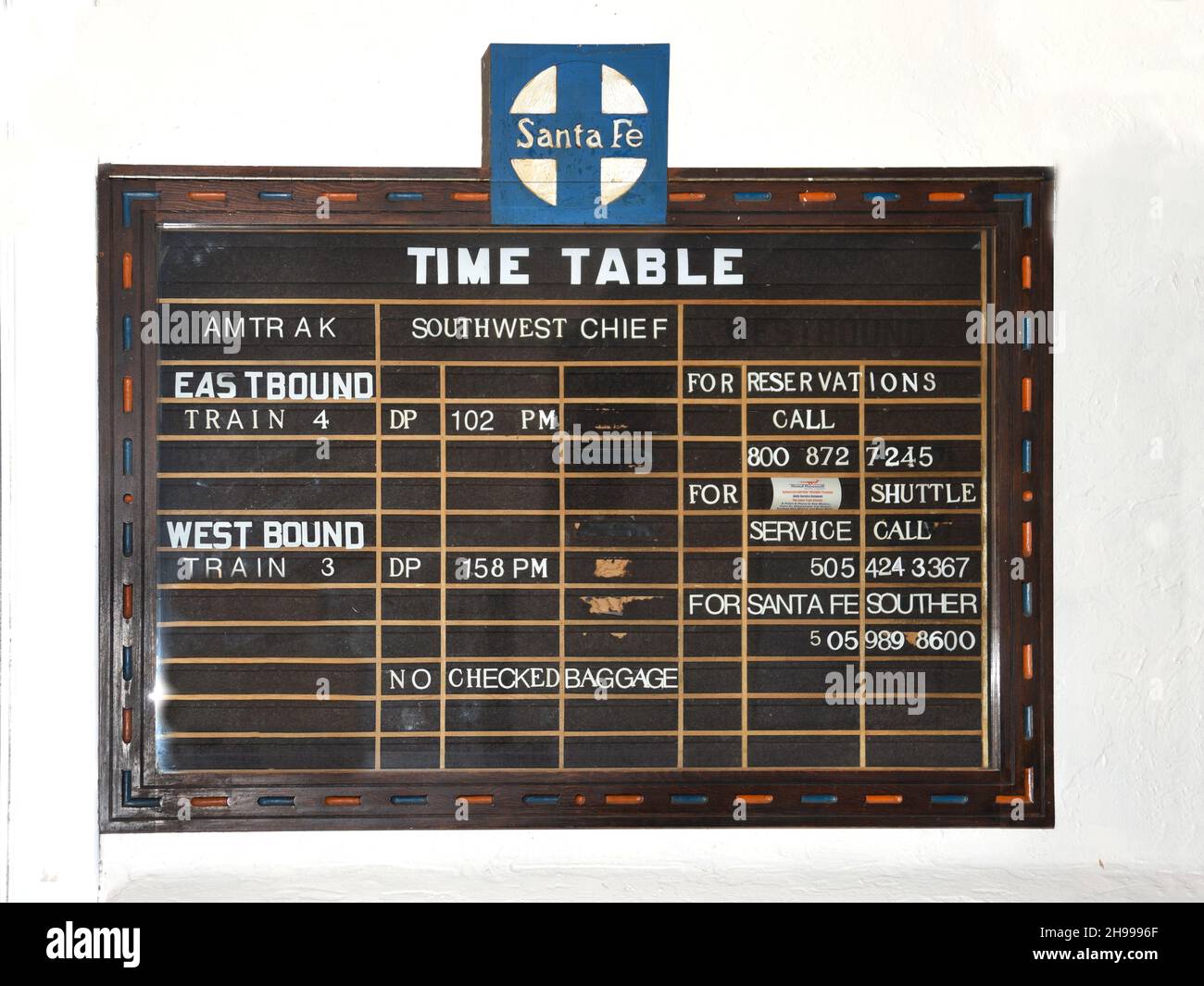 An Amtrak train time table in the depot in Lamy, New Mexico. The Southwest Chief operates between Chicago to Los Angeles with a quick stop in Lamy. Stock Photo