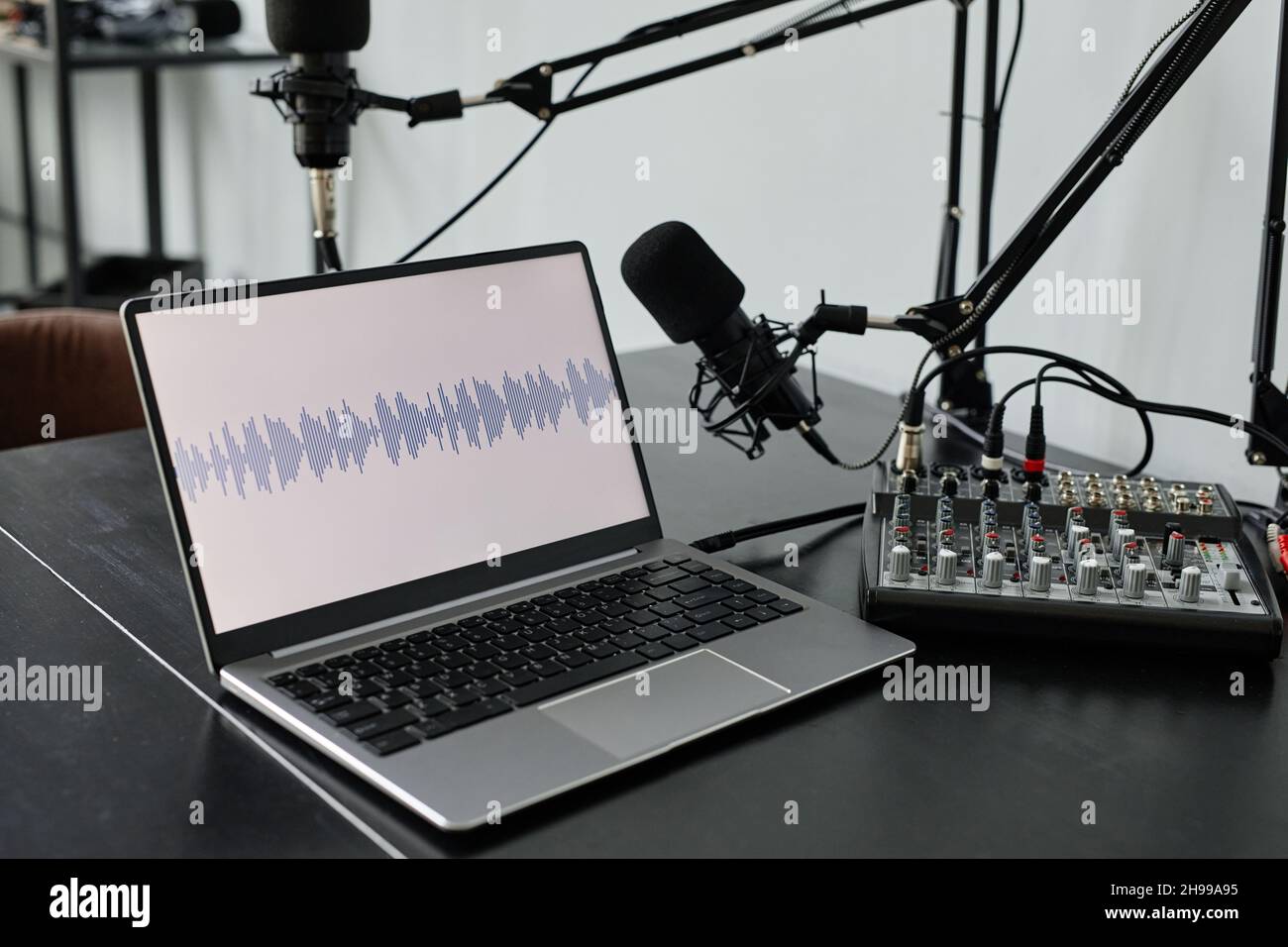 Close up of recording studio setup with laptop and microphone on stand