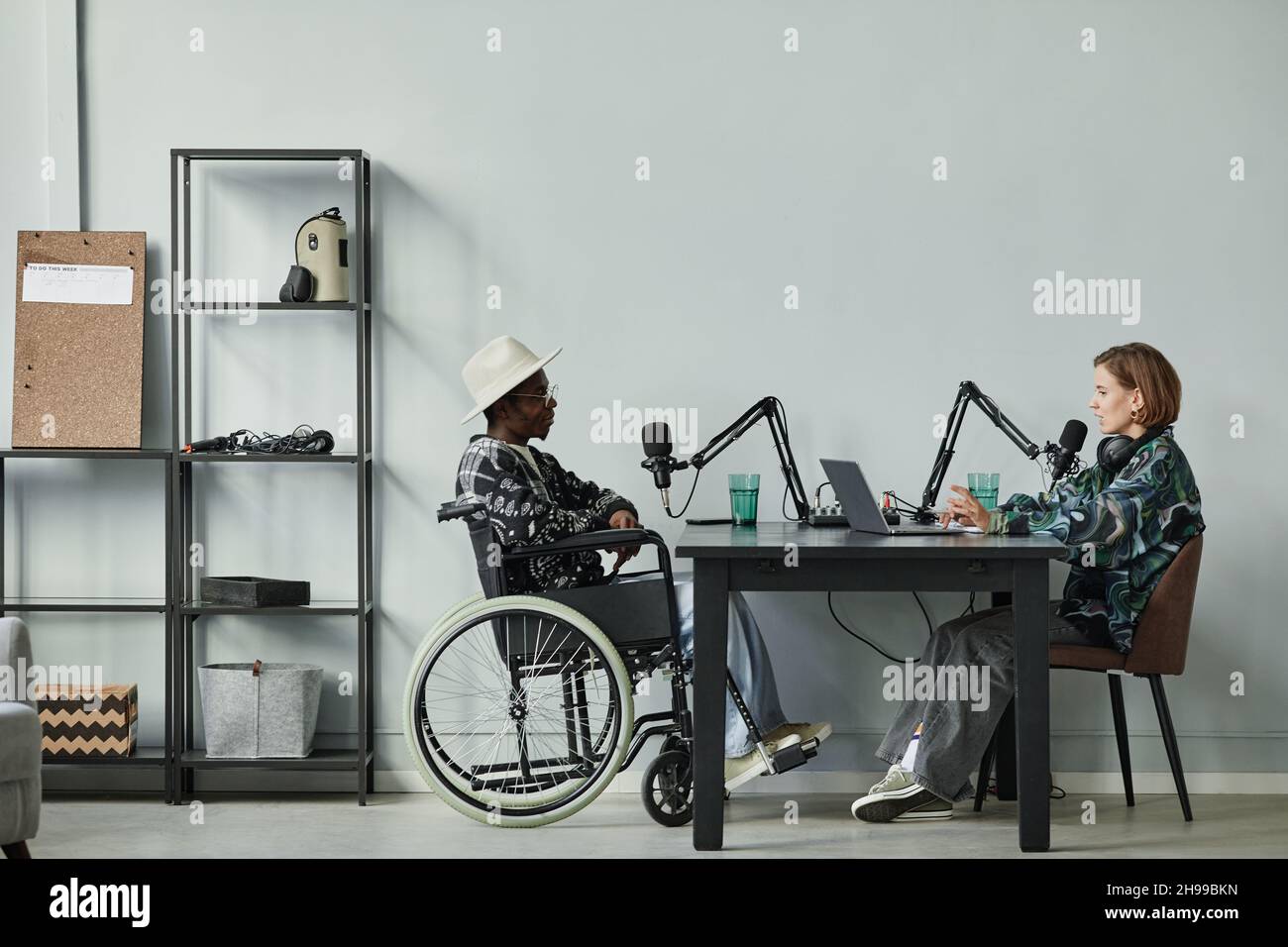 Full length portrait of person in wheelchair giving interview while