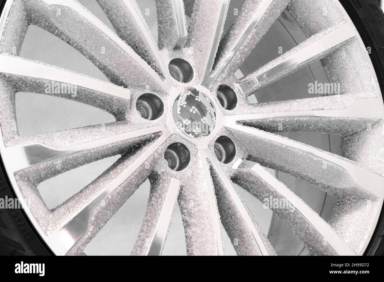 Inlaid with crystals stylish contemporary expensive shiny aluminum wheel disk demonstrated at exhibition extreme close view Stock Photo